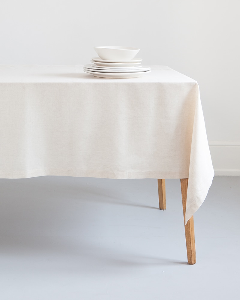 Mungo Kinsail Linen Table Cloth in Natural paired with white crockery for a crisp table setting.