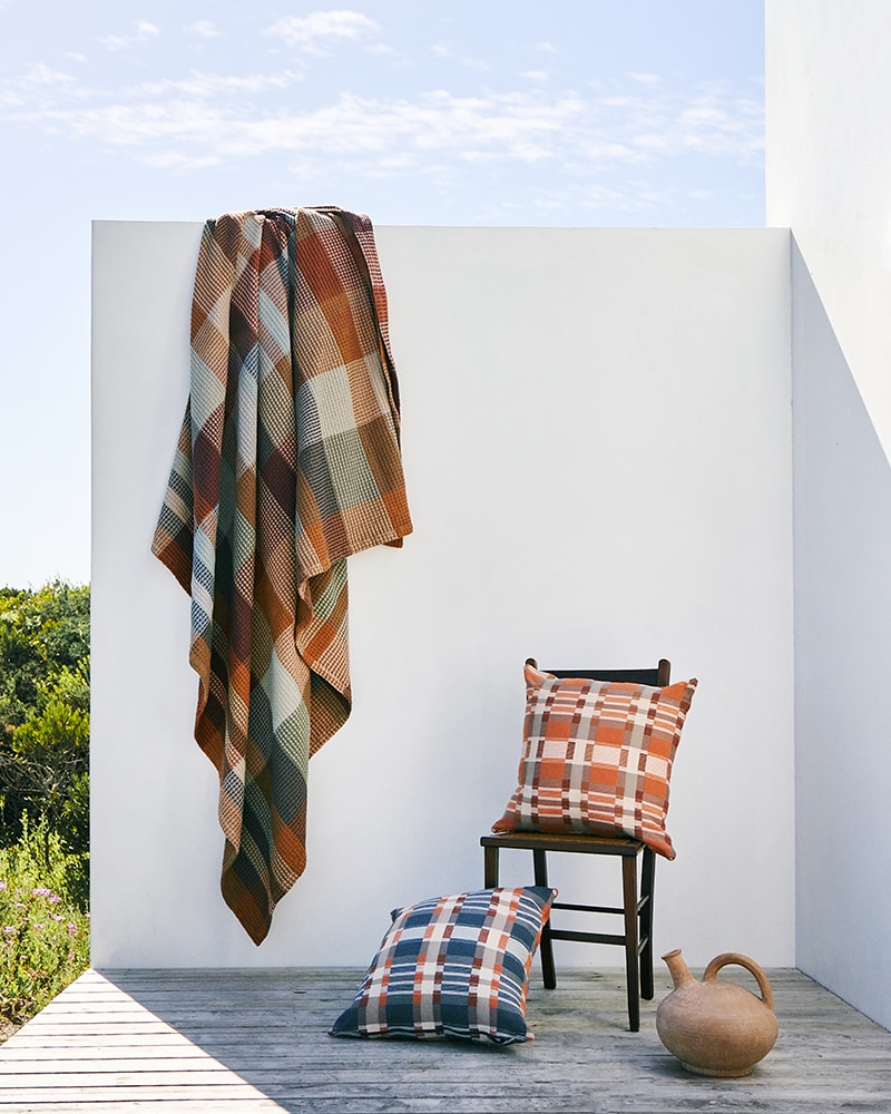 Mungo Vrou Vrou, a waffle weave cotton blanket, with mungo Skipping Block cushion covers