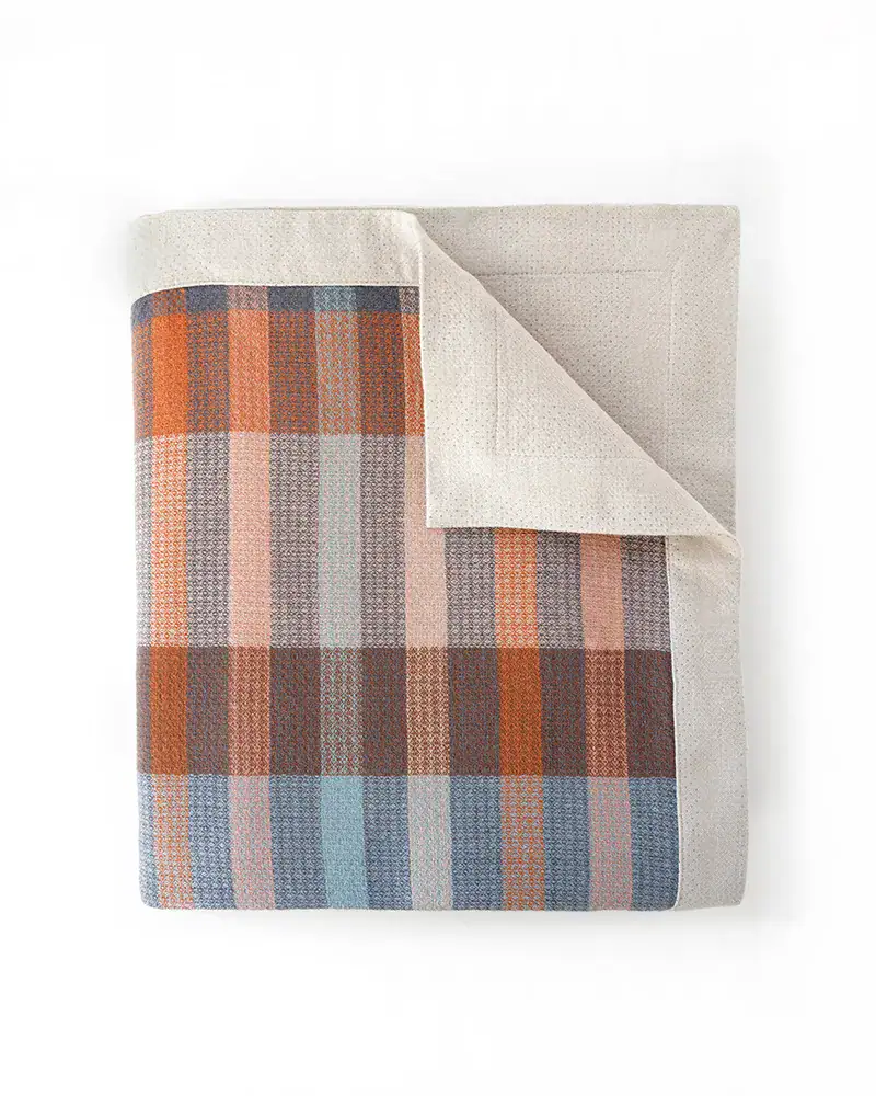 Textured blanket with woven detail